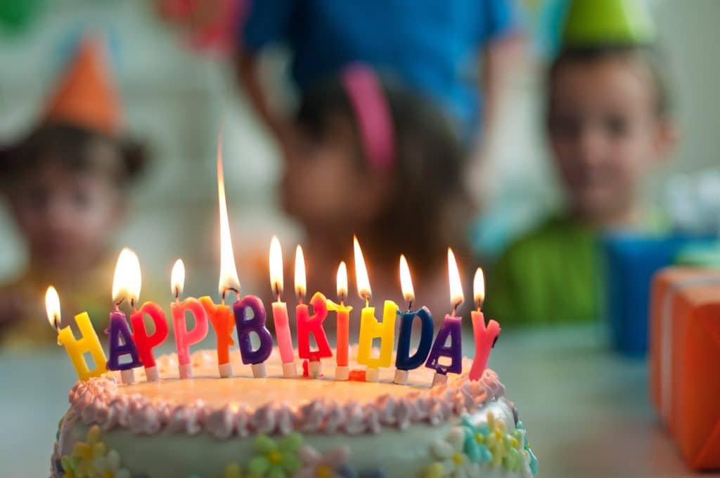 a birthday cake with happy birthday spelled out by candles